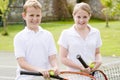 Two young friends on tennis court smiling Royalty Free Stock Photo