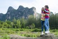 Two young girl have fun at beautiful landscape view of mountain and pine tree Royalty Free Stock Photo