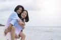 Two young girl having fun at beautiful beach