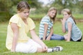 Two young girls bullying other young girl outdoors Royalty Free Stock Photo