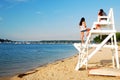 Two young girls chat on a lifeguard chair