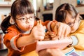 Two young girls with down syndrome diligently painting