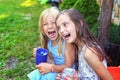 Two young girls have fun outside