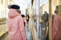 Two young girls having fun on beautiful winter day in Uzupis district in Vilnius, Lithuania. Cute children having a walk in winter Royalty Free Stock Photo