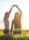 Two young girls having fun in the wheat field Royalty Free Stock Photo