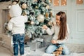 Two girls with santa hat laying in front of the christmas tree Royalty Free Stock Photo