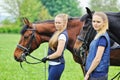 Two young girls with horses Royalty Free Stock Photo