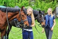 Two young girls with horses Royalty Free Stock Photo