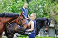 Two young girls with horses Royalty Free Stock Photo