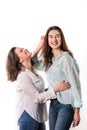 Two young girls hug and laugh indoors Royalty Free Stock Photo