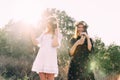 Two young girls hug during sunset in the field with wine glasses friendship concept copy space Royalty Free Stock Photo