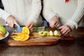 Two young girls in the kitchen talking and eating fruit, healthy lifestyle, close-up Royalty Free Stock Photo