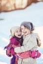 Two young girls laughing on sunny winter day Royalty Free Stock Photo