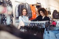 Two young girls look at clothing in store