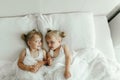 Two Little Girls Laying on a Bed Together Royalty Free Stock Photo