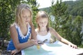 Two Young Girls in Mountain read the Map near Royalty Free Stock Photo