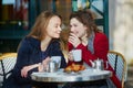 Two young girls in Parisian outdoor cafe Royalty Free Stock Photo