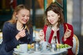 Two young girls in Parisian outdoor cafe Royalty Free Stock Photo