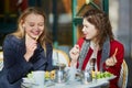 Two young girls in Parisian outdoor cafe Royalty Free Stock Photo