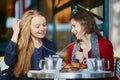 Two young girls in Parisian outdoor cafe Royalty Free Stock Photo