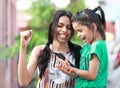 Two young girls in ponytail celebrating victory.