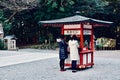Two young girls are praying at a temple in Japan Kagoshima