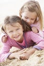 Two Young Girls Relaxing On Beach Royalty Free Stock Photo