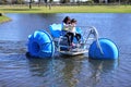 Two young girls  riding on a big wheel aqua bike water tricycle Royalty Free Stock Photo