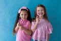 Two young girls show toothbrushes dentistry nice