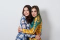 two young girls sisters or friends hug and smile looking at the frame Royalty Free Stock Photo