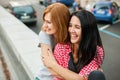 Two young girls sitting near road