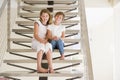 Two Young Girls Sitting On A Staircase At Home Royalty Free Stock Photo
