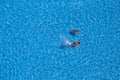 Two young girls swims in the swimming pool, view from above Royalty Free Stock Photo