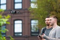 Two Young Handsome Men Launching Drone Quadcopter at Urban Stlilysh Contemporary Cityscape. Modern Device