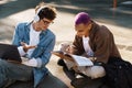 Two young handsome stylish students doing homework together Royalty Free Stock Photo