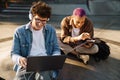 Two young handsome stylish students doing homework together Royalty Free Stock Photo