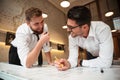 Two young happy businessmen working on a business plan