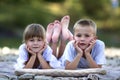 Two young happy cute blond children, boy and girl, brother and s