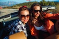 Two young happy girls having fun in the cabriolet outdoors Royalty Free Stock Photo