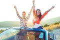 Two young happy girls having fun in the cabriolet outdoors Royalty Free Stock Photo