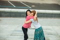 Two girls hugging in the street