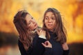 Two young fashion girls in black pullover walking outdoor Royalty Free Stock Photo