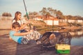 Two young happy little friends, boy and girl fishing on a lake in a sunny summer day Royalty Free Stock Photo