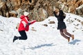 Two young happy teenage girls jumping with pleasure at snow Royalty Free Stock Photo