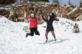 Two young happy teenage girls jumping with pleasure at snow Royalty Free Stock Photo