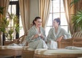 Two young happy women drinking tea at spa resort Royalty Free Stock Photo