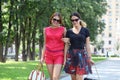 Two young happy women walking in the summer city Royalty Free Stock Photo