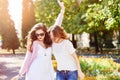 Two young happy women walking in the summer city Royalty Free Stock Photo