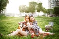 Two young hipster girls having fun on the picnic Royalty Free Stock Photo