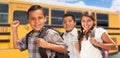 Excited Young Hispanic Boys and Girl Walking Near School Bus